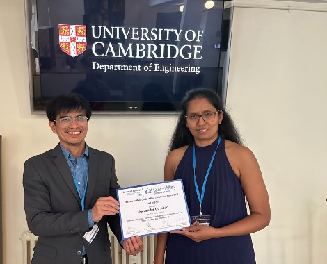 A man and women standing holding a certificate.